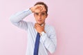 Young handsome businessman wearing shirt and tie standing over isolated pink background Touching forehead for illness and fever, Royalty Free Stock Photo
