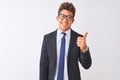 Young handsome businessman wearing suit and glasses over isolated white background doing happy thumbs up gesture with hand Royalty Free Stock Photo