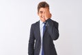 Young handsome businessman wearing suit standing over isolated white background covering one eye with hand, confident smile on Royalty Free Stock Photo