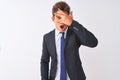 Young handsome businessman wearing suit standing over isolated white background peeking in shock covering face and eyes with hand, Royalty Free Stock Photo