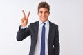 Young handsome businessman wearing suit standing over isolated white background showing and pointing up with fingers number two Royalty Free Stock Photo