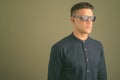 Young handsome businessman wearing sunglasses against colored background Royalty Free Stock Photo