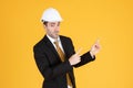 Young handsome businessman wears suit and construction helmet