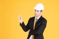 Young handsome businessman wears suit and construction helmet