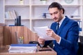 Young handsome businessman working in the office Royalty Free Stock Photo