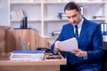 Young handsome businessman working in the office Royalty Free Stock Photo