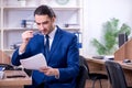 Young handsome businessman working in the office Royalty Free Stock Photo