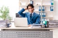 The young handsome busy employee sitting in office Royalty Free Stock Photo