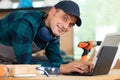 young handsome carpenter with laptop Royalty Free Stock Photo