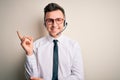 Young handsome caucasian business man wearing call center headset at customer service with a big smile on face, pointing with hand Royalty Free Stock Photo