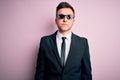 Young handsome caucasian business man wearing funny thug life glasses with serious expression on face Royalty Free Stock Photo