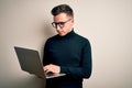 Young handsome caucasian business man wearing glasses using computer laptop with a confident expression on smart face thinking Royalty Free Stock Photo