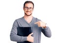 Young handsome caucasian man holding business folder pointing finger to one self smiling happy and proud Royalty Free Stock Photo