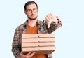 Young handsome caucasian man holding delivery pizza box with angry face, negative sign showing dislike with thumbs down, rejection Royalty Free Stock Photo