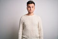 Young handsome caucasian man wearing casual winter sweater over white isolated background puffing cheeks with funny face Royalty Free Stock Photo