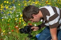 Young handsome caucasian photographer/videographer in botanic gardens.