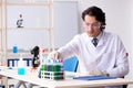 The young handsome chemist working in the lab Royalty Free Stock Photo