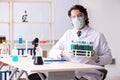 The young handsome chemist working in the lab Royalty Free Stock Photo