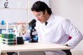 The young handsome chemist working in the lab Royalty Free Stock Photo