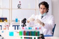 The young handsome chemist working in the lab Royalty Free Stock Photo