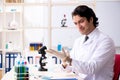 The young handsome chemist working in the lab Royalty Free Stock Photo