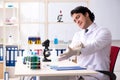 The young handsome chemist working in the lab Royalty Free Stock Photo