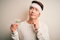 Young handsome chinese man injured for accident wearing bandage on head asking for help serious face thinking about question, very Royalty Free Stock Photo