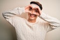 Young handsome chinese man injured for accident wearing bandage and strips on head Doing heart shape with hand and fingers smiling