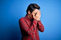 Young handsome chinese man wearing casual shirt and glasses over blue background with sad expression covering face with hands Royalty Free Stock Photo