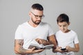 Young handsome clever daddy helps his son with homework Royalty Free Stock Photo