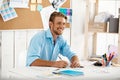 Young handsome confident smiling businessman working sitting at table writing in notebook. White modern office interior Royalty Free Stock Photo