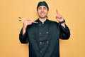 Young handsome cooker man with blue eyes wearing uniform and hat using chopsticks surprised with an idea or question pointing