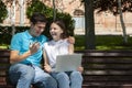 Young handsome couple using notebook in the public park Royalty Free Stock Photo