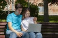 Young handsome couple using notebook in the public park Royalty Free Stock Photo