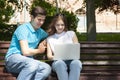 Young handsome couple using notebook in the public park Royalty Free Stock Photo