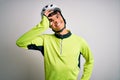 Young handsome cyclist man wearing security bike helmet over isolated white background doing ok gesture with hand smiling, eye Royalty Free Stock Photo