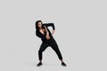 Young handsome young dancer dressed in black pants, a sweatshirt on a naked torso is dancing street dance. He makes Royalty Free Stock Photo