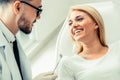 Young dentist talks with patient in dental clinic. Royalty Free Stock Photo