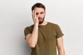 Young handsome dissapointed unhappy depressed man with a hand on his face Royalty Free Stock Photo