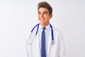 Young handsome doctor man wearing stethoscope over isolated white background smiling looking to the side and staring away thinking Royalty Free Stock Photo