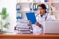 The young handsome doctor working in the clinic Royalty Free Stock Photo