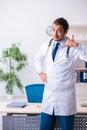 Young male handsome doctor working in the clinic Royalty Free Stock Photo