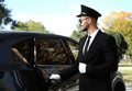 Young handsome driver opening luxury car door Royalty Free Stock Photo