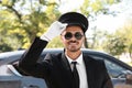 Young handsome driver standing near luxury car Royalty Free Stock Photo