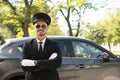 Young handsome driver standing near luxury car. Royalty Free Stock Photo