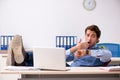 The young handsome employee working in the office Royalty Free Stock Photo