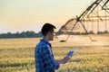 Farmer with tablet in field at sunset Royalty Free Stock Photo