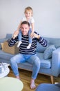 Young handsome father holding his beautiful toddler child daugther at shoulders Royalty Free Stock Photo