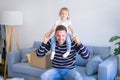 Young handsome father holding his beautiful toddler child daugther at shoulders Royalty Free Stock Photo