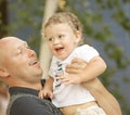 Young handsome Father and little baby Son playing and laughing at summer day